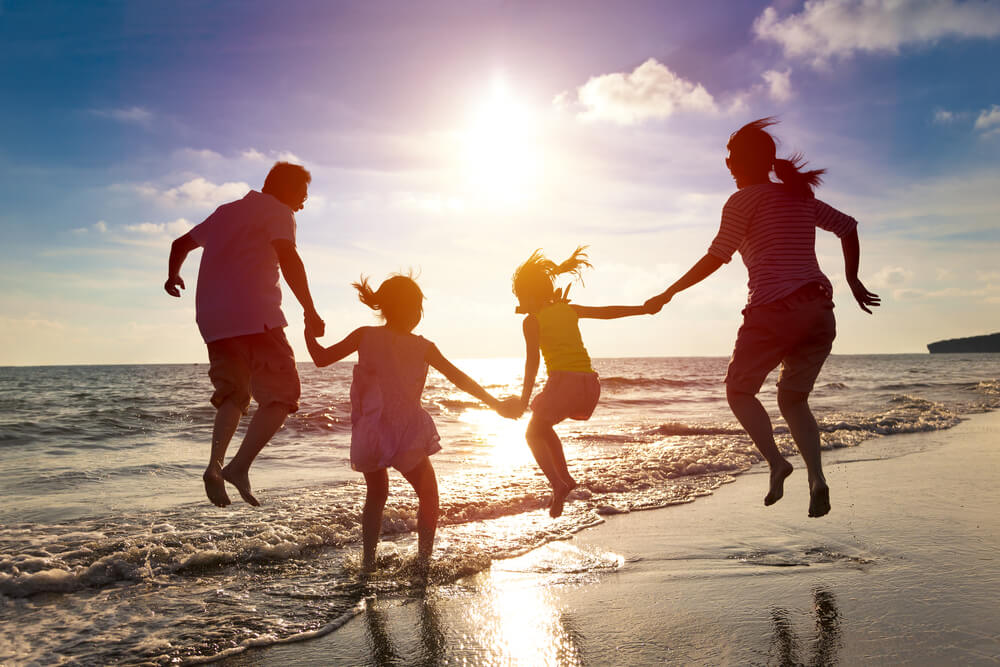 A family on the beach during a Panama City Beach spring break getaway.