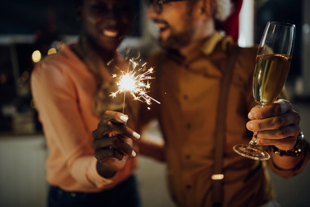 A couple with champagne and a sparkler on New Year's Eve in Panama City Beach.