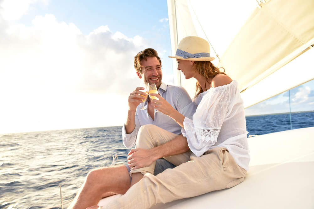 A couple enjoying a sunset sail during their romantic Florida getaway.
