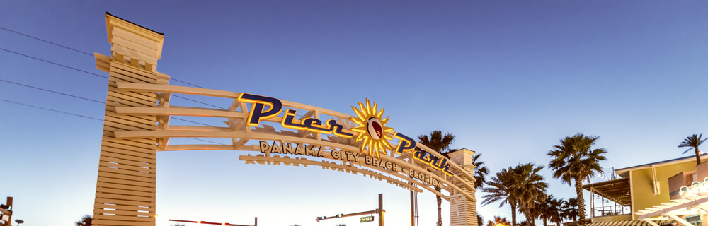 The sign welcoming visitors to Pier Park, an outdoor mall with several restaurants and shops.