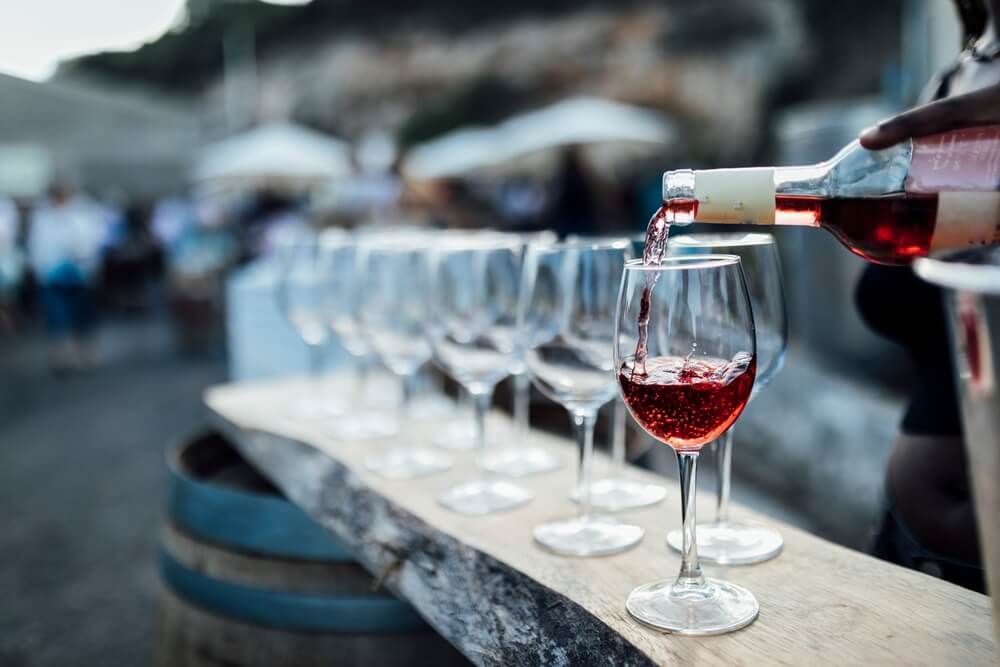 Wine being poured into glasses at UNwineD Panama City Beach.